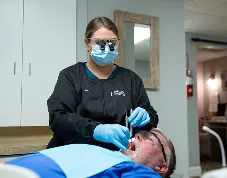 Kim helping a patient